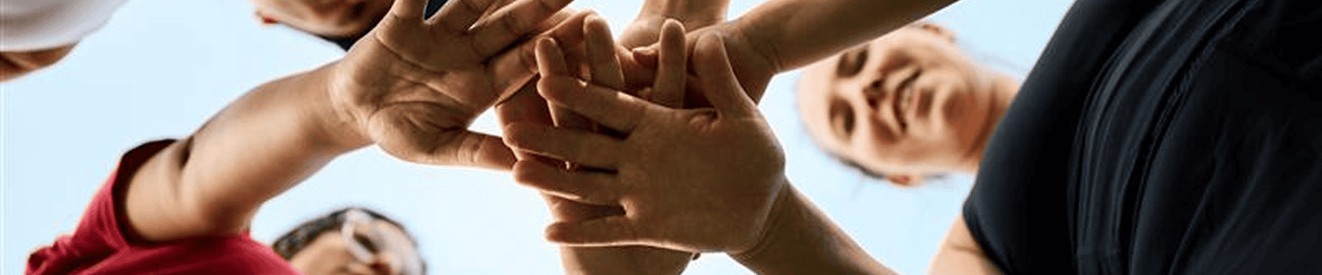 People putting their hands in a circle