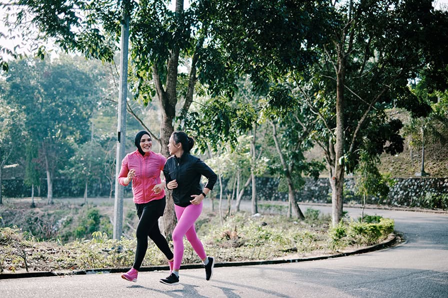 two happy women running