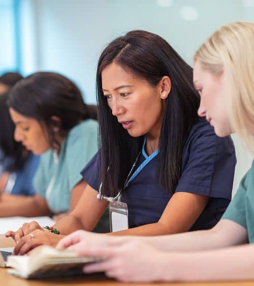 Health professional discussing lesson with student