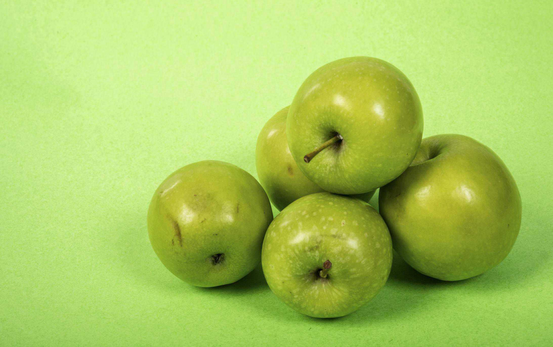 Baked Apples Stacked on Green Background