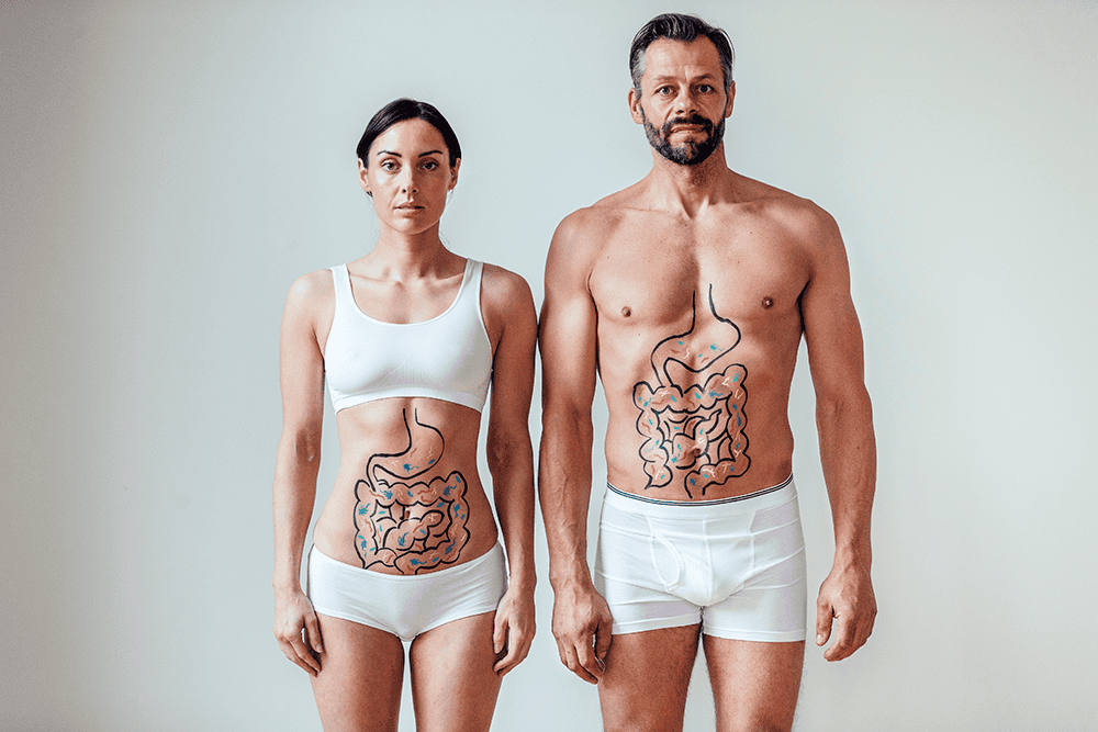 man and woman with diagram showing intestines drawn on their stomachs