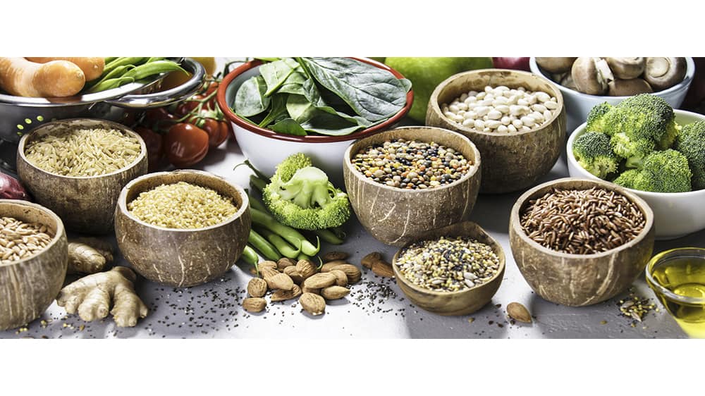 Health food concept with legumes, grains, seeds and organic vegetables
