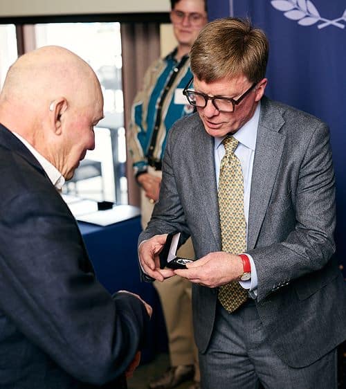 Two people standing and talking at a Kellion Ceremony