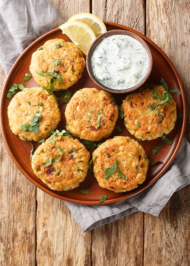 Lemon dill patties on a plate with serving sauce