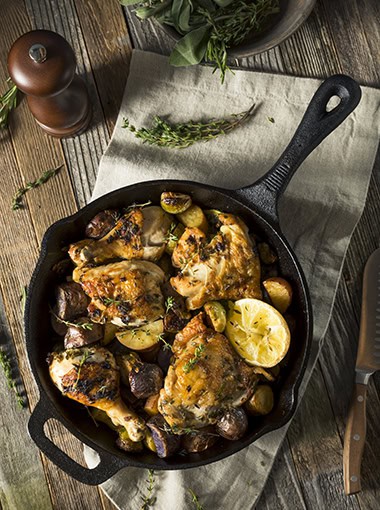 Homemade Baked Chicken in a Skillet with Potatoes and Veggies