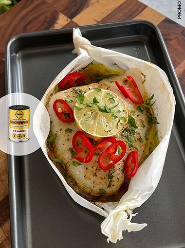 Lemon pepper fish boat with tomato on a baking tray, with Mingle overlay