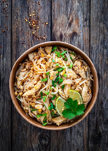 Pad Thai with chicken nuggets and rice noodles in peanut and tamarind sauce