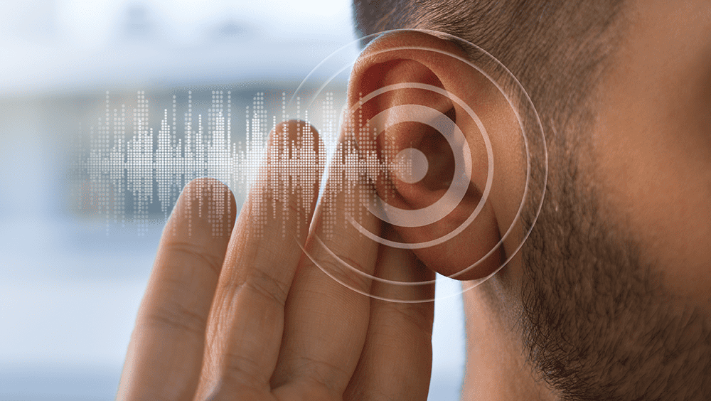 man with head to ear indicating hearing