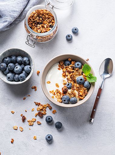 Maple granola in a bowl, with blueberries in another bowl on the side