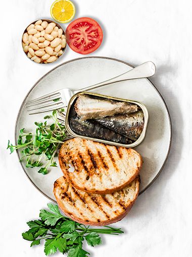 Sardines and toast on a plate, ready to eat