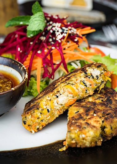 Tofu patties on a plate with vegetables