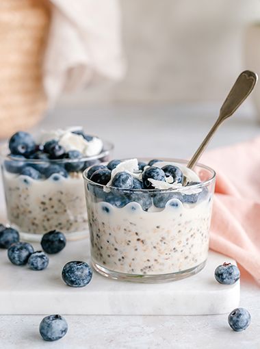 Overnight oats and chia mix in a serving glass, with blueberries on top