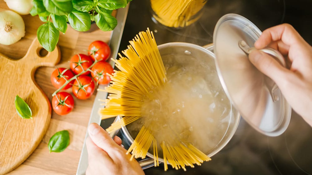 carbs effect on BGLs, boiling pot of pasta cooking with tomatoes and basil