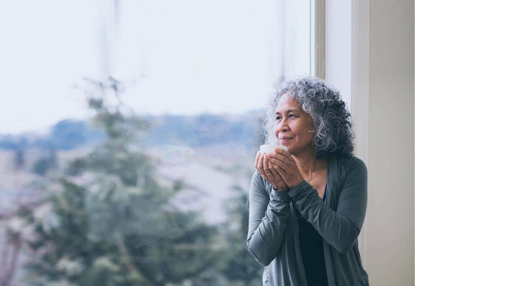 reflective thinking, woman holding mug