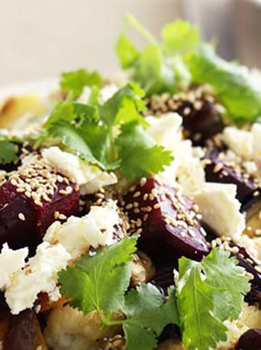 Baked Vegetables with dates and feta topped with sesame seeds and coriander