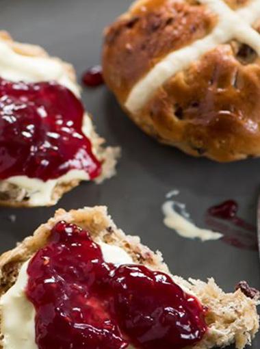 Scones topped with jam and cream