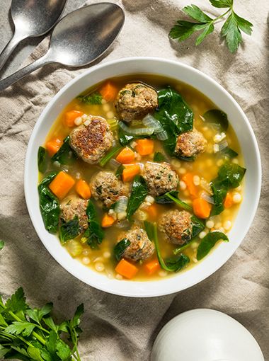 Vegetable and chicken meatball soup in a bowl, ready to eat