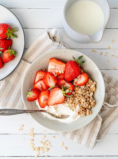Strawberries and yoghurt in a bowl with granola