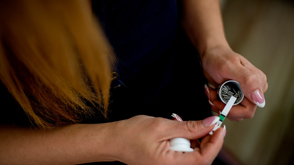 Woman using a test strip