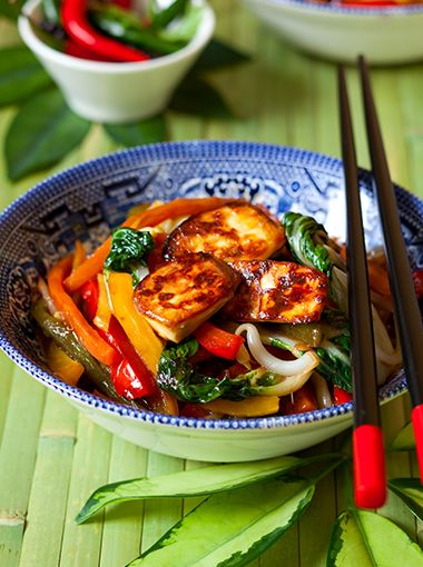 Tofu and vegetable stir fry in a bowl, ready to eat