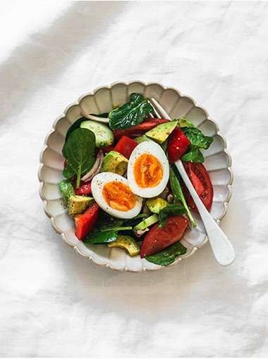 Delicious breakfast, snack - boiled egg, fresh vegetable salad