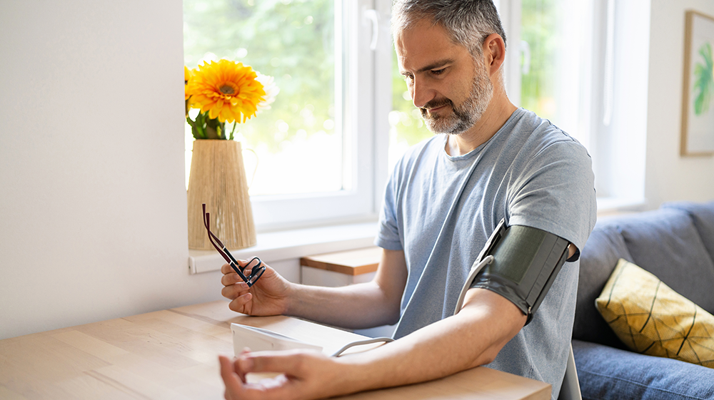 man taking blood pressure at home