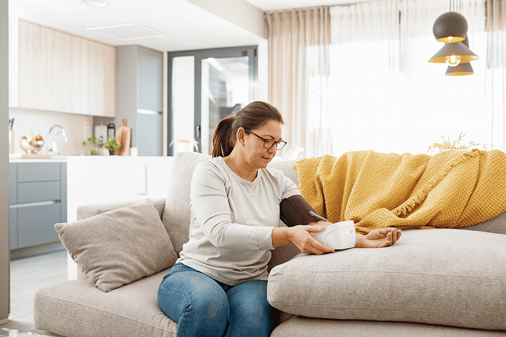 woman measuring blood pressure at home