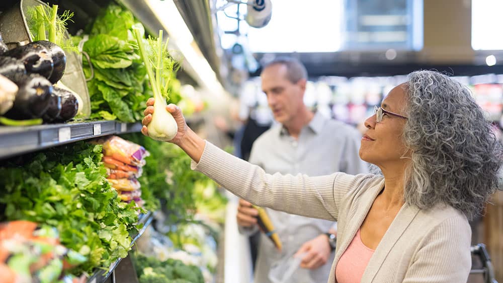 food claims, man and woman at supermarket selecting produce