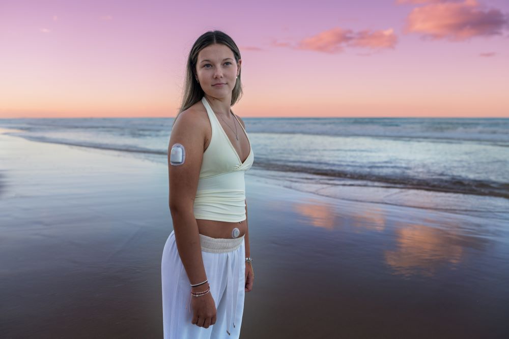Young woman standing on beach at sunset